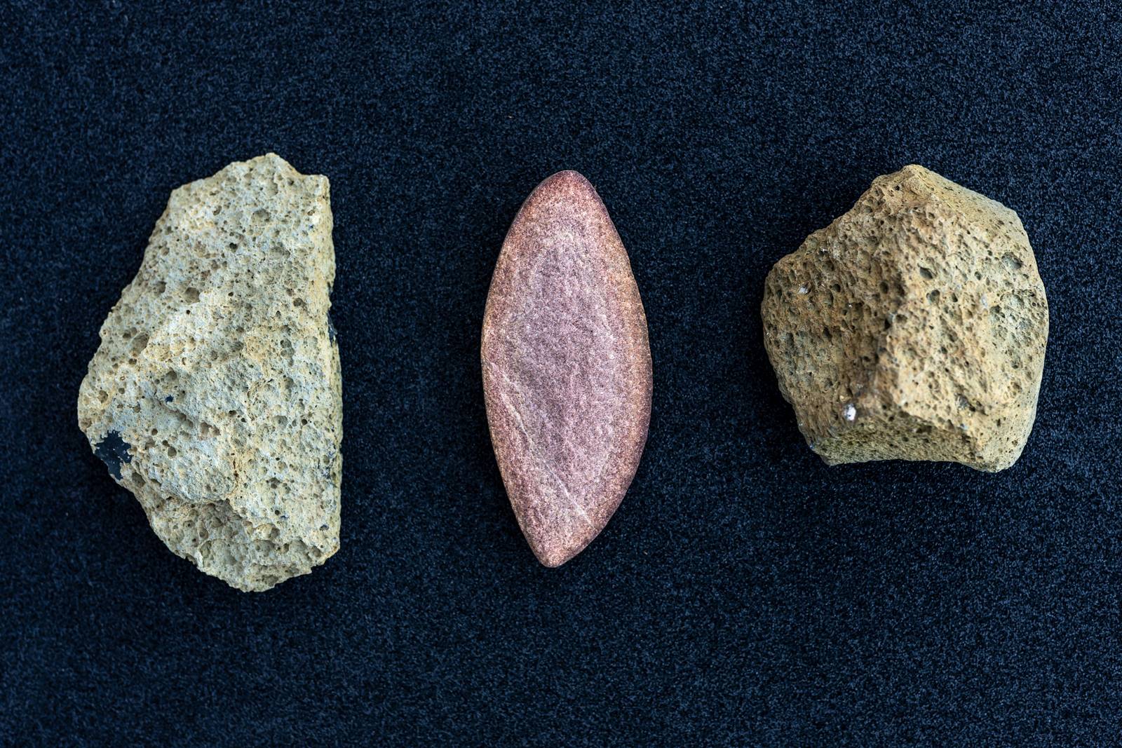 The photo depicts two lithic artefacts and a clast of quartzite found in the oldest loess and palaeosol sediment layer of the archaeological site of Korolevo in Transcarpathia, Ukraine.