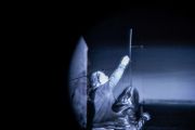 At each site, we set up an ornithological mist net in order to capture an owl. I try to assist Martin with the setup, but it takes me a few attempts to feel useful. This image was taken through the night-vision thermal imaging device.