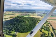 The sites are located near the villages of Budyně nad Ohří, Poplze, and Písty, within sight of the legendary Mount Říp.